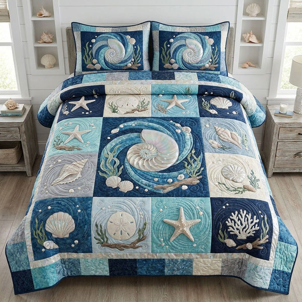 The Coastal Passage quilted 3-piece bedding set on a made bed in a light coastal bedroom