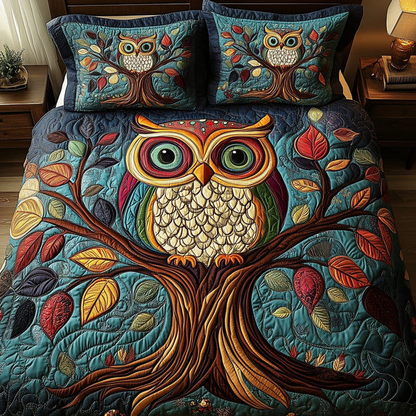 The Owlchemy quilted 3-piece bedding set on a made bed with two matching pillow shams