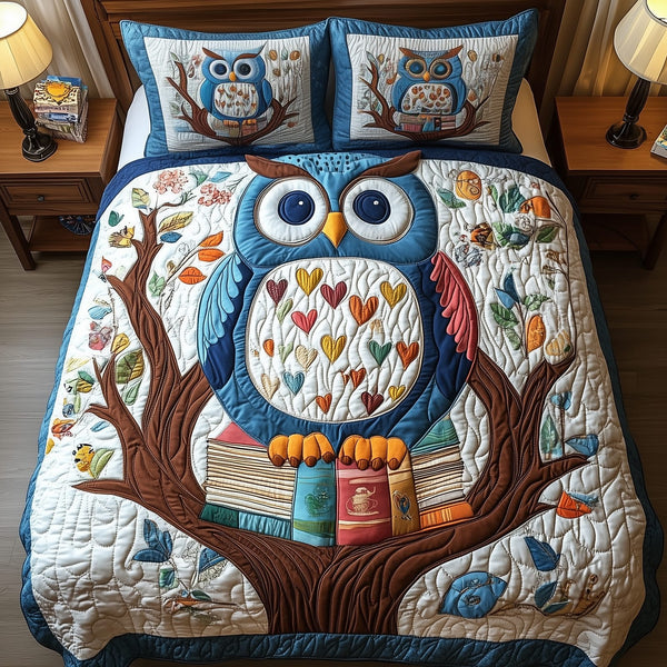 The Owlchemy quilted 3-piece bedding set on a made bed with two matching pillow shams