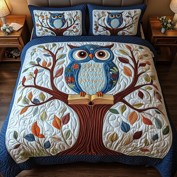 The Owlchemy quilted 3-piece bedding set on a made bed with two matching pillow shams