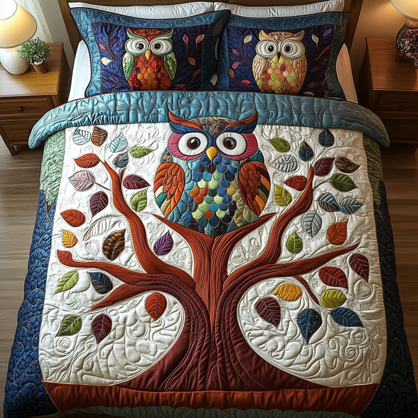 The Owlchemy quilted 3-piece bedding set on a made bed with two matching pillow shams