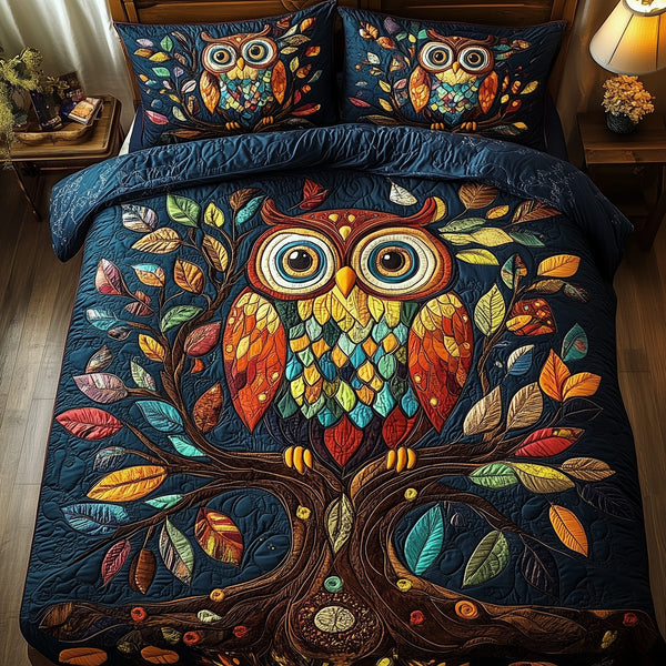 The Owlchemy quilted 3-piece bedding set on a made bed with two matching pillow shams