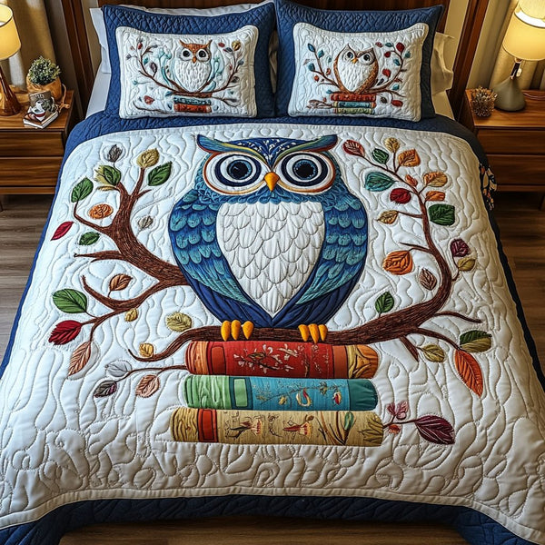 The Owlchemy quilted 3-piece bedding set on a made bed with two matching pillow shams
