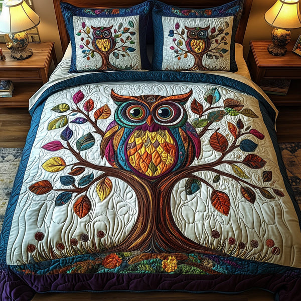 The Owlchemy quilted 3-piece bedding set on a made bed with two matching pillow shams