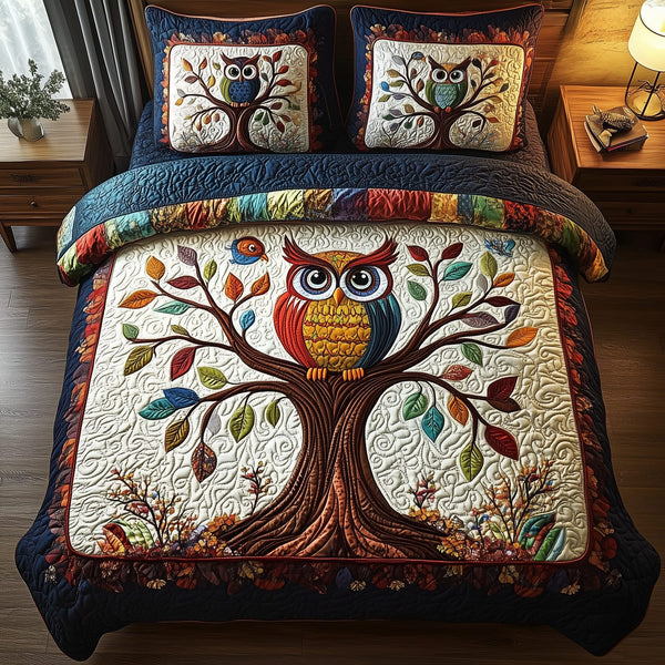 The Owlchemy quilted 3-piece bedding set on a made bed with two matching pillow shams