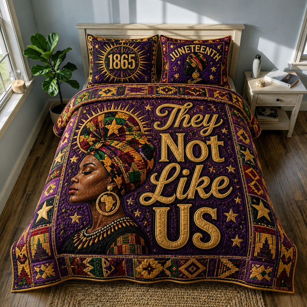 They Not Like Us African Queen Juneteenth quilted 3-piece bedding set on a made bed in a warmly lit bedroom