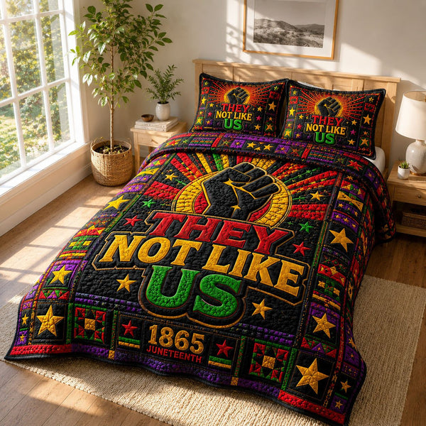 They Not Like Us Black Excellence quilted 3-piece bedding set on a made bed with two matching pillow shams