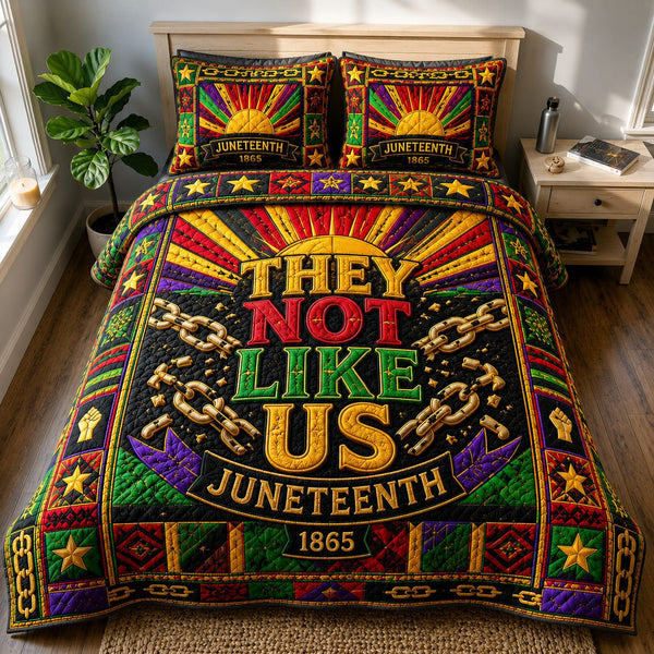 They Not Like Us Broken Chains quilted 3-piece bedding set on a made bed with two matching pillow shams