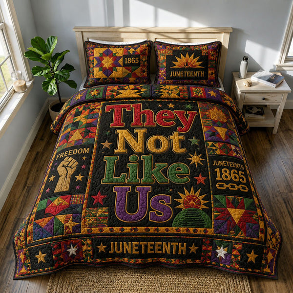 They Not Like Us Freedom Juneteenth quilted 3-piece bedding set on a made bed in a warmly lit bedroom