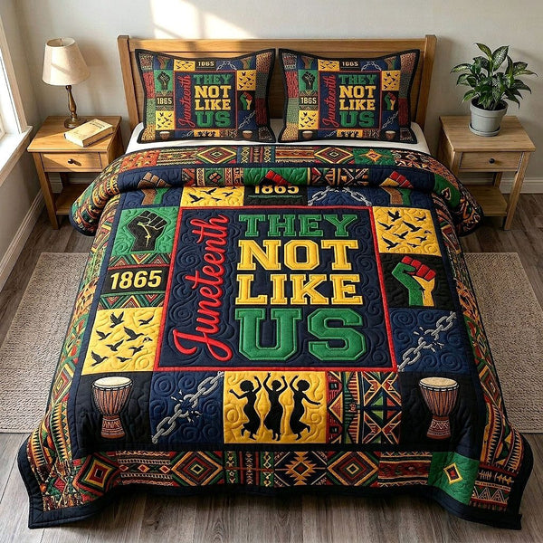 They Not Like Us quilted 3-piece bedding set on a made bed with two matching pillow shams