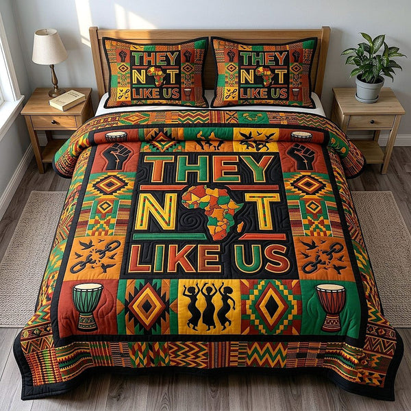 They Not Like Us quilted 3-piece bedding set on a made bed with two matching pillow shams