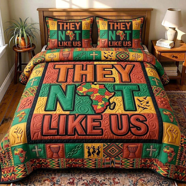 They Not Like Us quilted 3-piece bedding set on a made bed with two matching pillow shams