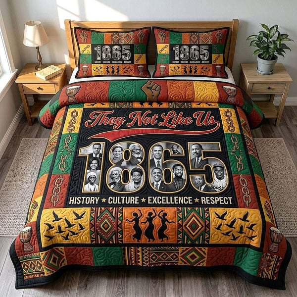 They Not Like Us quilted 3-piece bedding set on a made bed with two matching pillow shams