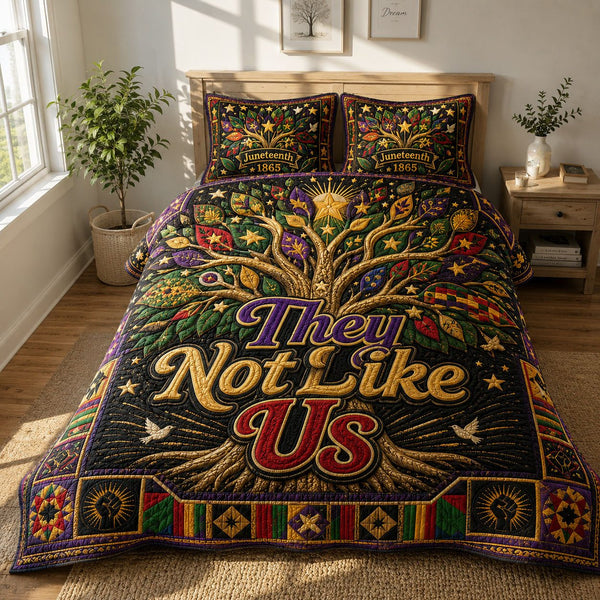 They Not Like Us Unity Tree Juneteenth quilted 3-piece bedding set on a made bed in a warmly lit bedroom
