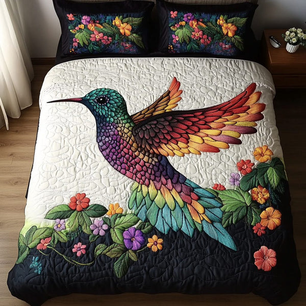 Tiny Wings quilted 3-piece bedding set on a made bed with two matching pillow shams