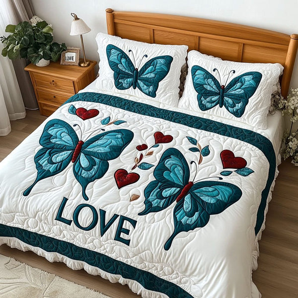Transformative Love quilted 3-piece bedding set on a made bed with two matching pillow shams