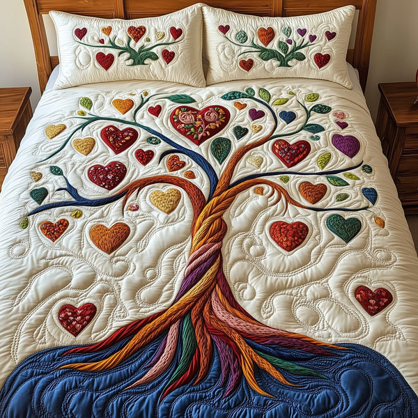 Tree Of Heart quilted 3-piece bedding set on a made bed with two matching pillow shams