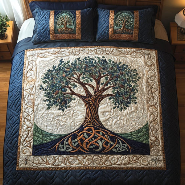 Tree of Tranquility quilted 3-piece bedding set on a made bed with two matching pillow shams