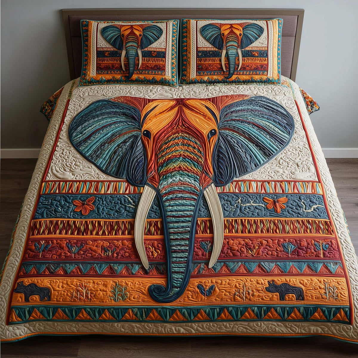 Tribal Elephant quilted 3-piece bedding set on a made bed with two matching pillow shams