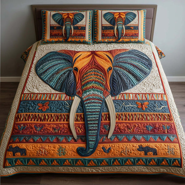 Tribal Elephant quilted 3-piece bedding set on a made bed with two matching pillow shams