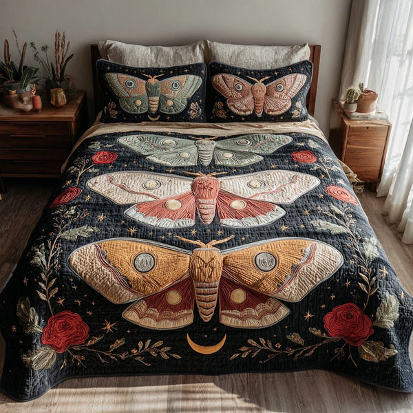 Trio Moths quilted 3-piece bedding set on a made bed with two matching pillow shams