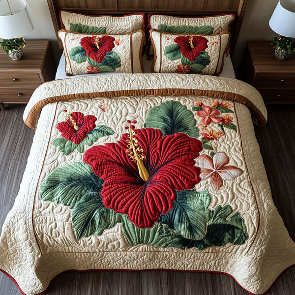 Tropical Hibiscus quilted 3-piece bedding set on a made bed in a light coastal bedroom