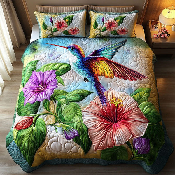 Tropical Hummingbird quilted 3-piece bedding set on a made bed in a light coastal bedroom