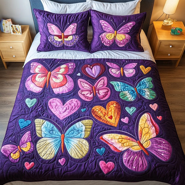 Velvet Butterflies quilted 3-piece bedding set on a made bed with two matching pillow shams