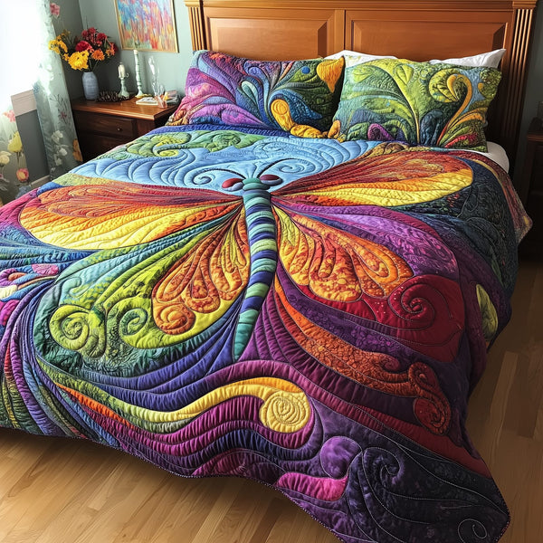 Vibrant Dragonfly quilted 3-piece bedding set on a made bed with two matching pillow shams
