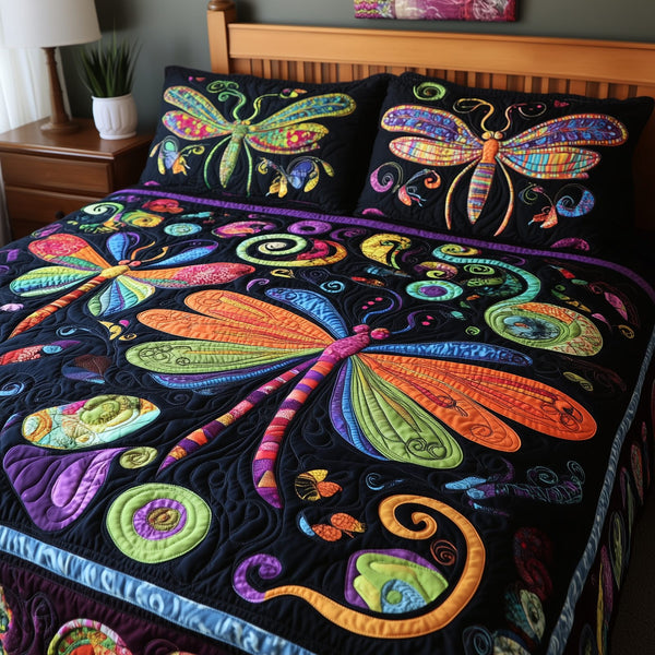 Vibrant Dragonfly quilted 3-piece bedding set on a made bed with two matching pillow shams