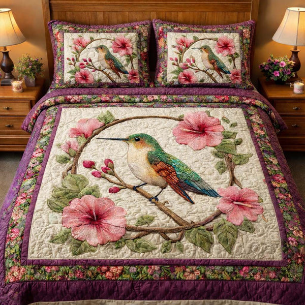 Vintage Garden Hummingbird quilted 3-piece bedding set on a made bed in a farmhouse bedroom