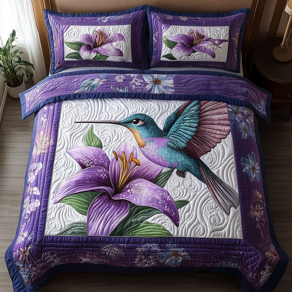 Violet Hummingbird quilted 3-piece bedding set on a made bed with two matching pillow shams