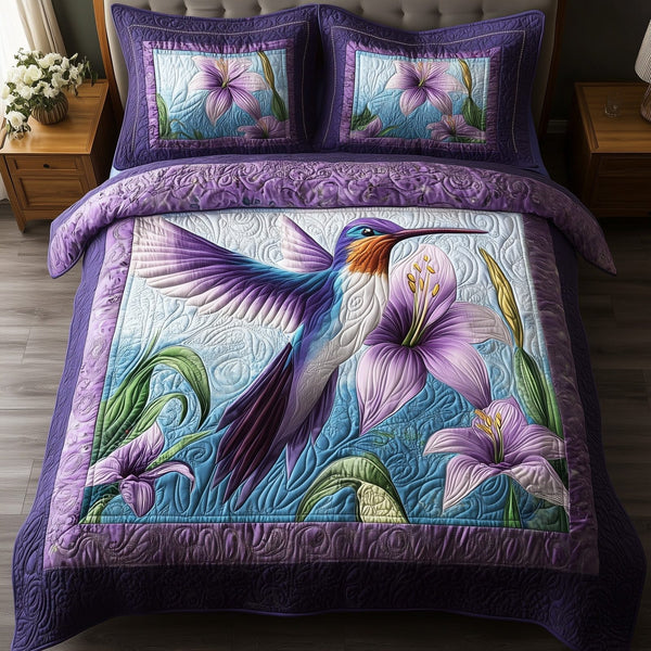 Violet Hummingbird quilted 3-piece bedding set on a made bed with two matching pillow shams
