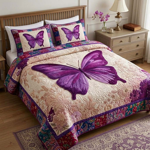 Violet Wings quilted 3-piece bedding set on a made bed with two matching pillow shams