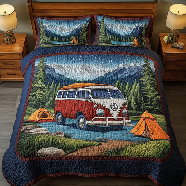 Wanderlust Retreat quilted 3-piece bedding set on a made bed with two matching pillow shams
