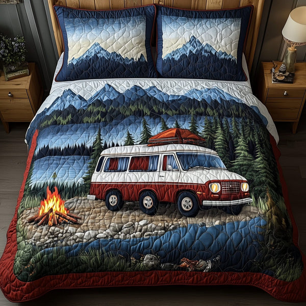 Wanderlust Retreat quilted 3-piece bedding set on a made bed with two matching pillow shams