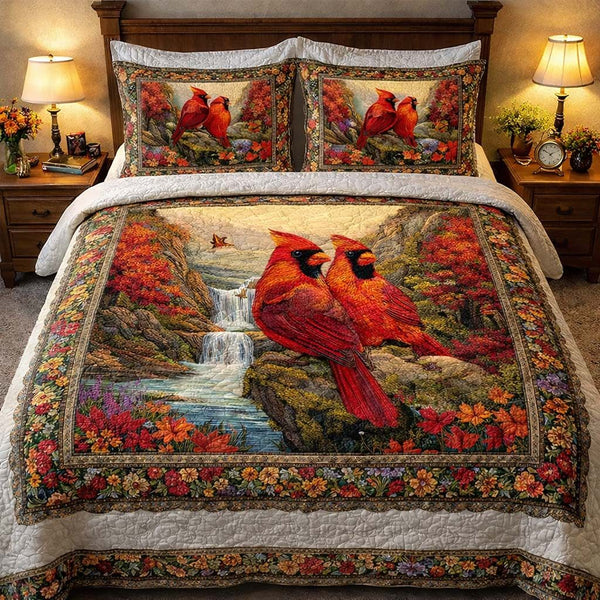 Waterfall Haven Cardinals quilted 3-piece bedding set on a made bed with two matching pillow shams