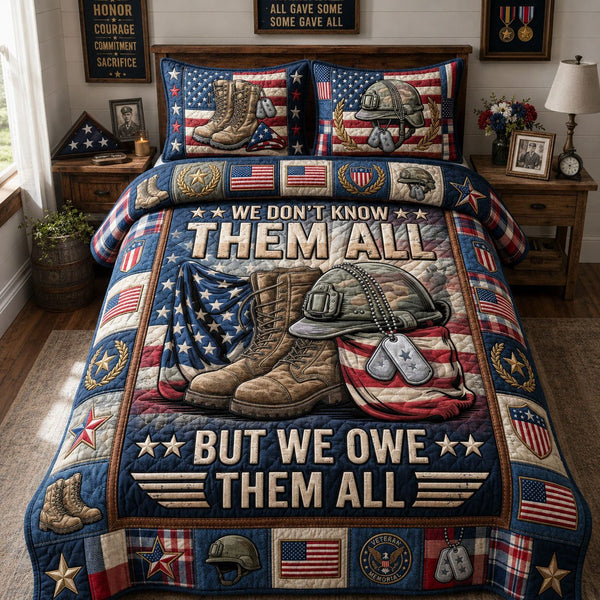 We Owe Them All quilted 3-piece bedding set on a made bed with two matching pillow shams
