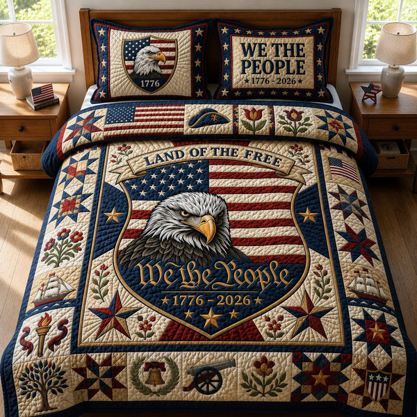 We The People quilted 3-piece bedding set on a made bed with two matching pillow shams