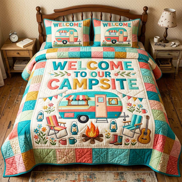 Welcome Camper quilted 3-piece bedding set on a made bed with two matching pillow shams