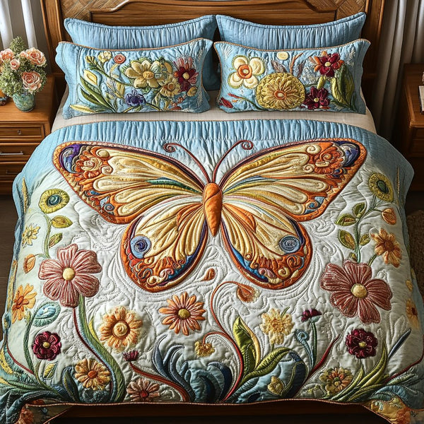 Whimsy Winged Dreams quilted 3-piece bedding set on a made bed with two matching pillow shams
