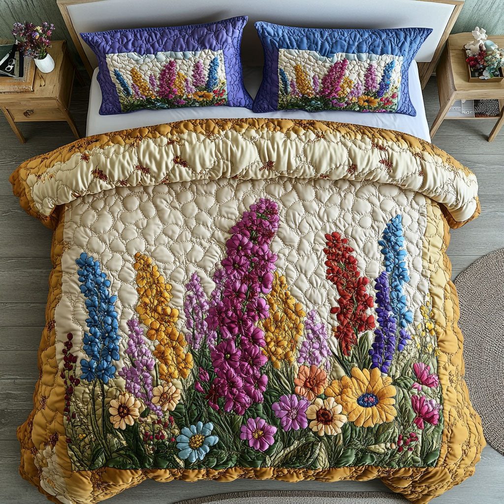 Whispering Delphinium quilted 3-piece bedding set on a made bed with two matching pillow shams
