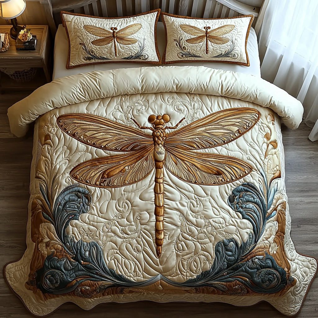 Whispering Dragonfly quilted 3-piece bedding set on a made bed with two matching pillow shams