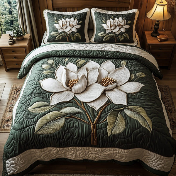 White Magnolia Grace quilted 3-piece bedding set on a made bed with two matching pillow shams