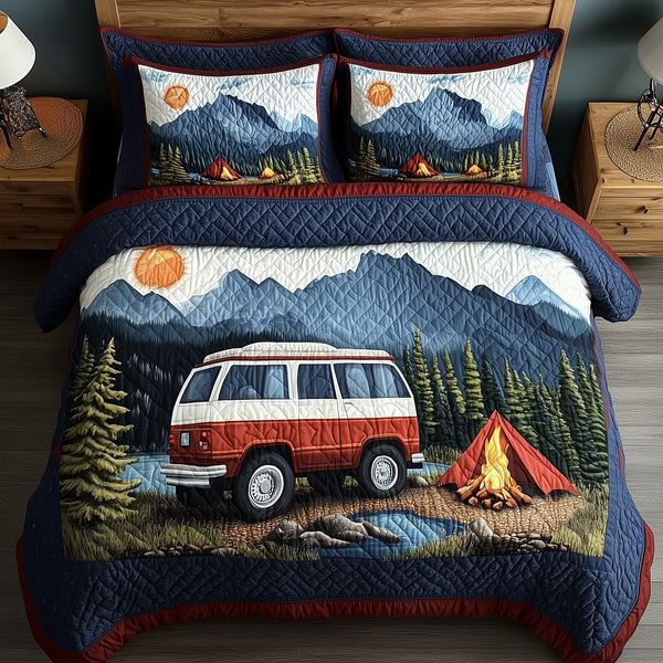 Wilderness Wander quilted 3-piece bedding set on a made bed with two matching pillow shams