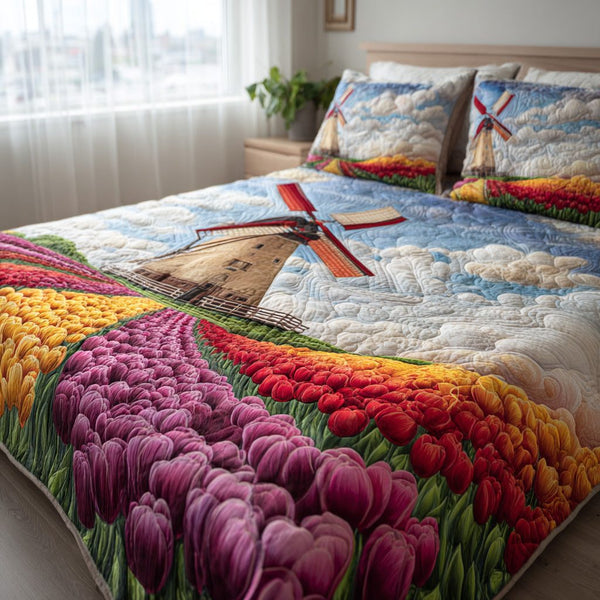 Windmill Blooms quilted 3-piece bedding set on a made bed with two matching pillow shams