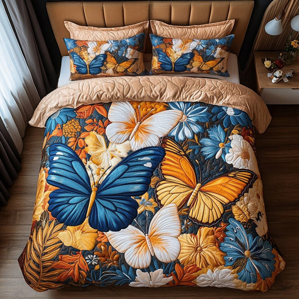 Winged Beauty quilted 3-piece bedding set on a made bed with two matching pillow shams