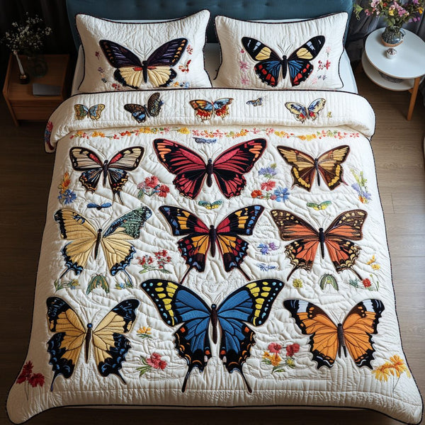 Winged Beauty quilted 3-piece bedding set on a made bed with two matching pillow shams