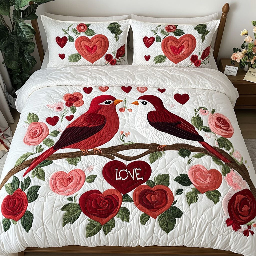 Winged Hearts quilted 3-piece bedding set on a made bed with two matching pillow shams