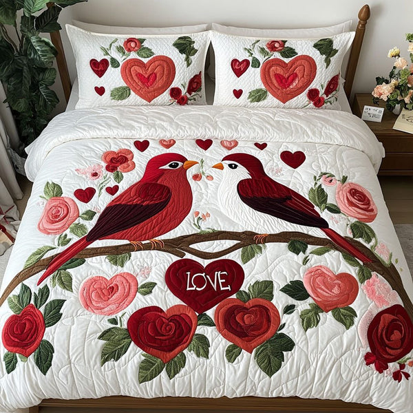 Winged Hearts quilted 3-piece bedding set on a made bed with two matching pillow shams